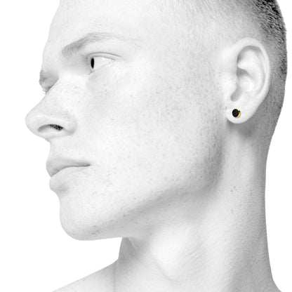 Sign earrings for him and her. Black and gold. Gold-plated sterling silver. Scherning Copenhagen